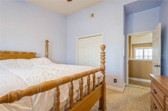 bedroom featuring light tile patterned floors, baseboards, a closet, and visible vents