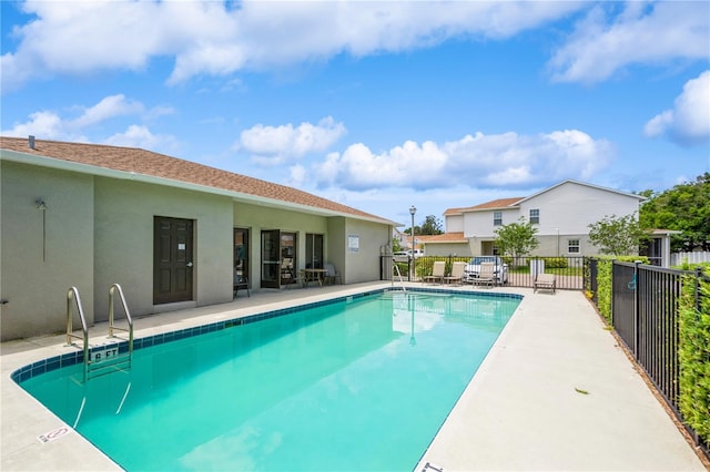 pool featuring a patio and fence