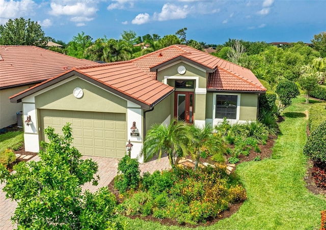 1358 Cielo Ct, North Venice, FL 34275 - mediterranean / spanish house with a tile roof, a garage, stucco siding, and driveway