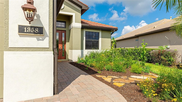 1358 Cielo Ct, North Venice, FL 34275 - property entrance featuring stucco siding and a tiled roof