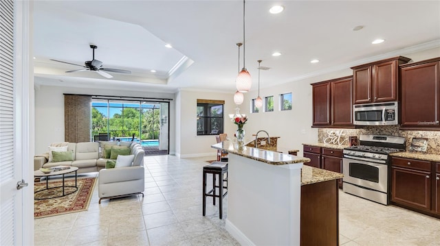1358 Cielo Ct, North Venice, FL 34275 - kitchen with light stone countertops, crown molding, stainless steel appliances, and tasteful backsplash