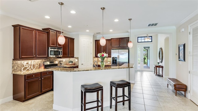 1358 Cielo Ct, North Venice, FL 34275 - kitchen with stone counters, stainless steel appliances, visible vents, arched walkways, and decorative backsplash