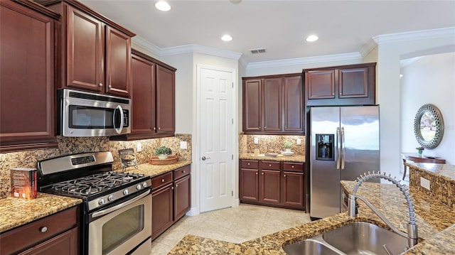 1358 Cielo Ct, North Venice, FL 34275 - kitchen with a sink, visible vents, appliances with stainless steel finishes, light stone counters, and ornamental molding