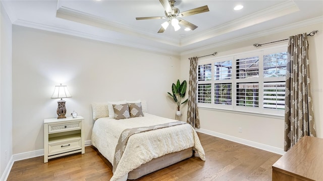 1358 Cielo Ct, North Venice, FL 34275 - bedroom featuring ornamental molding, a tray ceiling, and wood finished floors