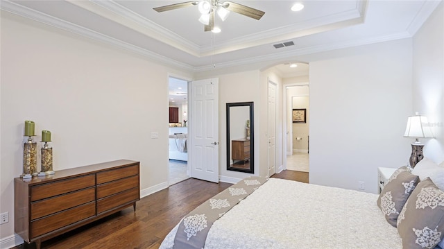 1358 Cielo Ct, North Venice, FL 34275 - bedroom with a tray ceiling, recessed lighting, visible vents, arched walkways, and dark wood-style floors