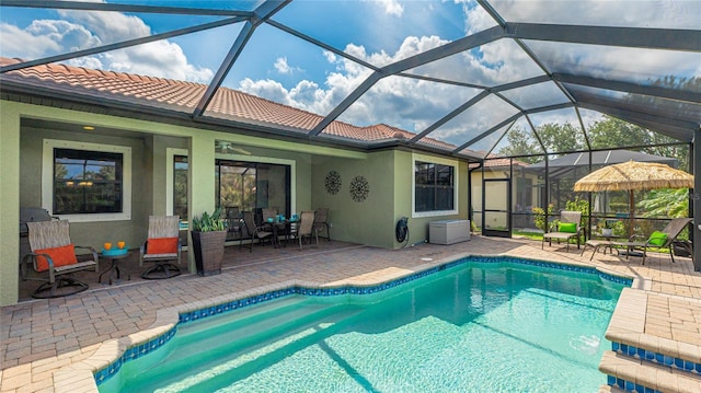 1358 Cielo Ct, North Venice, FL 34275 - outdoor pool featuring a patio area, ceiling fan, and glass enclosure