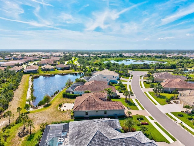 drone / aerial view featuring a water view and a residential view