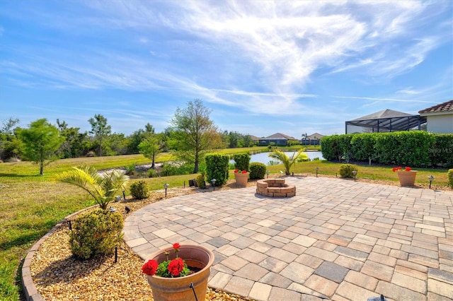 view of patio / terrace featuring a fire pit and a water view