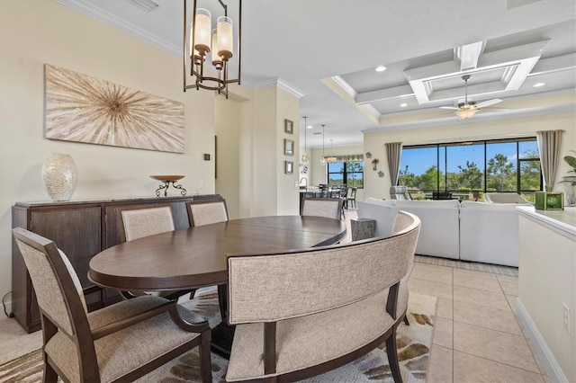 dining space with crown molding, light tile patterned flooring, and an inviting chandelier