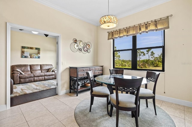 dining room featuring tile patterned floors, ornamental molding, and baseboards