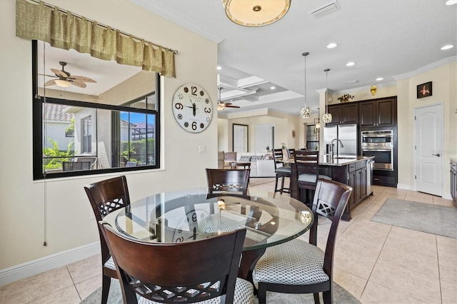 dining room with light tile patterned flooring, a ceiling fan, crown molding, and baseboards