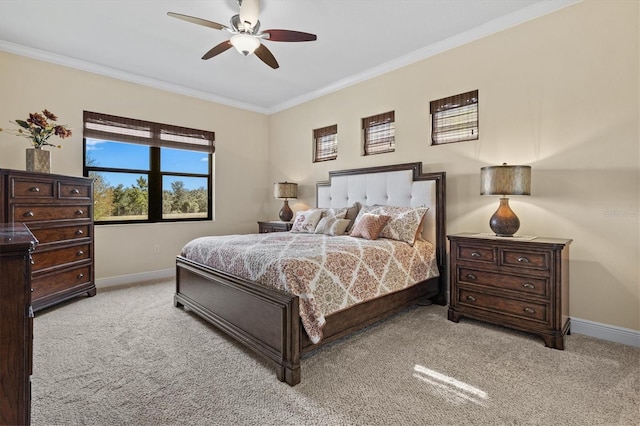 bedroom with baseboards, ornamental molding, a ceiling fan, and light colored carpet