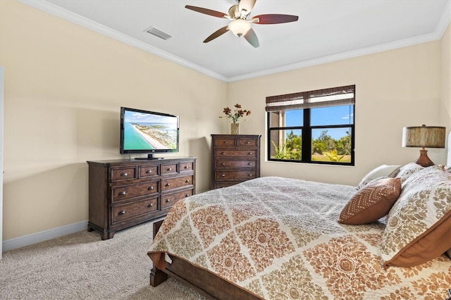 carpeted bedroom with baseboards, visible vents, ornamental molding, and a ceiling fan