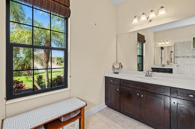 bathroom with tile patterned flooring, vanity, and baseboards