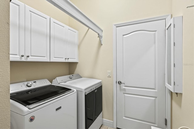 laundry area with cabinet space and washing machine and clothes dryer