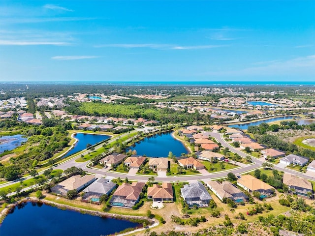 birds eye view of property featuring a residential view and a water view