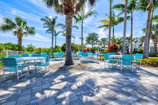 view of patio with outdoor dining area and fence