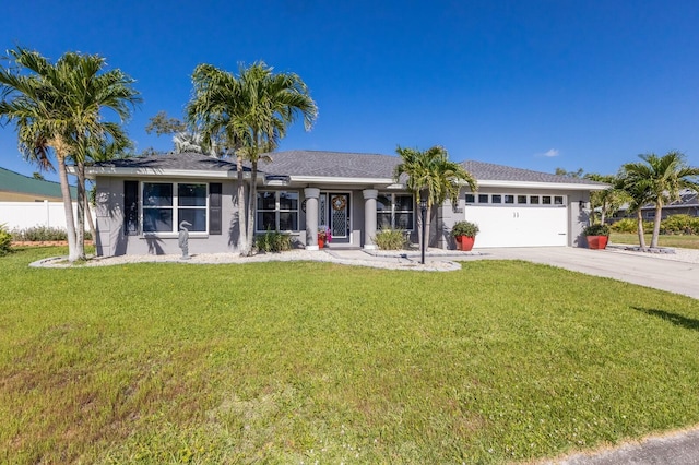 ranch-style home with concrete driveway, an attached garage, a front yard, and stucco siding