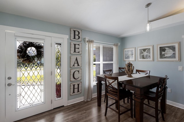 dining space featuring baseboards and dark wood-style floors
