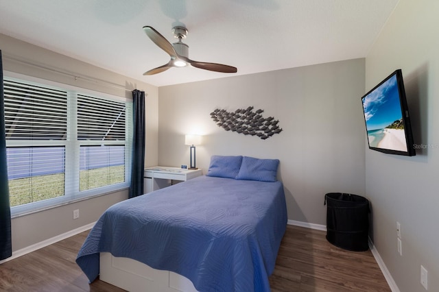 bedroom with baseboards, ceiling fan, and wood finished floors