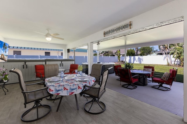 view of patio / terrace with fence, a ceiling fan, and outdoor dining space