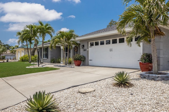 3889 Canopy Way, Sarasota, FL 34235 - ranch-style home featuring driveway, stucco siding, an attached garage, and a front lawn