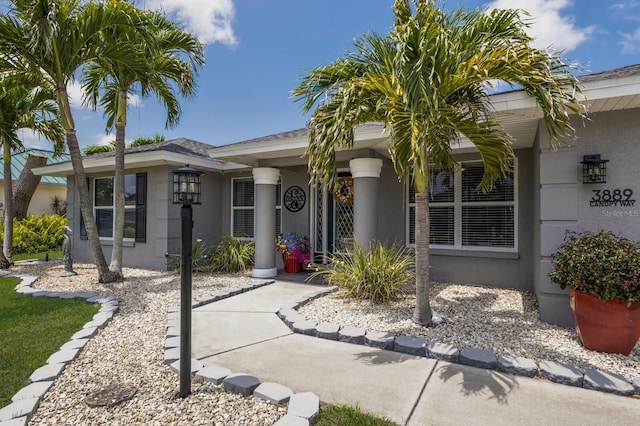 3889 Canopy Way, Sarasota, FL 34235 - view of exterior entry featuring stucco siding