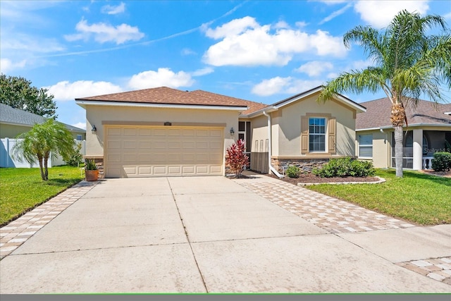 ranch-style house with a front yard, stone siding, stucco siding, and concrete driveway