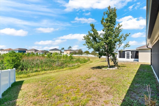 view of yard featuring fence and a residential view