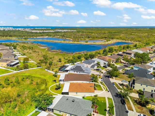 drone / aerial view featuring a water view and a residential view