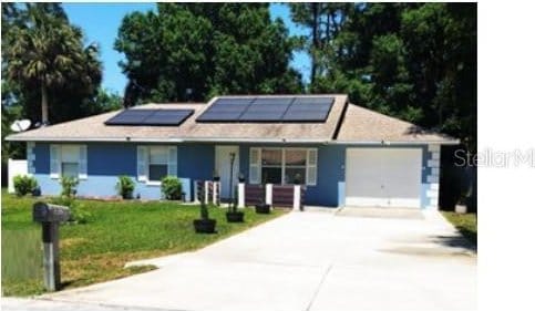 25 Philox Ln, Palm Coast, FL 32164 - ranch-style house with driveway, a front lawn, a garage, solar panels, and a porch