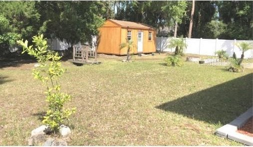 25 Philox Ln, Palm Coast, FL 32164 - view of yard with a storage unit and an outdoor structure