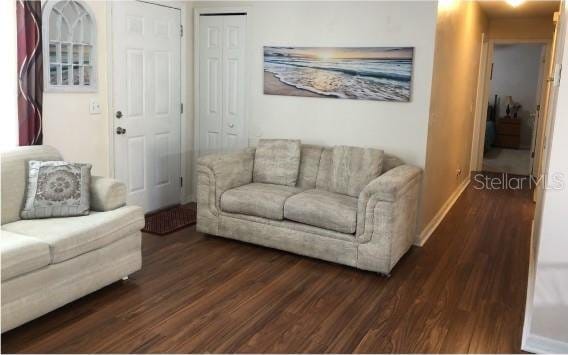 25 Philox Ln, Palm Coast, FL 32164 - living area with dark wood finished floors and baseboards