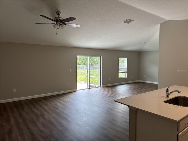 475 Tobias St SE, Palm Bay, FL 32909 - unfurnished living room with vaulted ceiling, a sink, dark wood finished floors, a ceiling fan, and baseboards