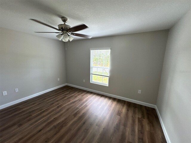 475 Tobias St SE, Palm Bay, FL 32909 - unfurnished room featuring dark wood-style flooring, ceiling fan, baseboards, and a textured ceiling