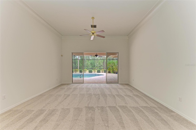 spare room with crown molding, ceiling fan, and light carpet