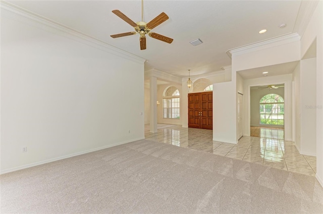 spare room with a ceiling fan, crown molding, baseboards, light carpet, and recessed lighting