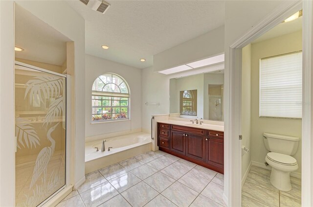 full bathroom featuring visible vents, a garden tub, vanity, toilet, and a stall shower