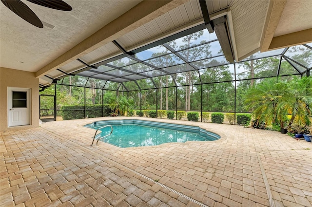 pool featuring a ceiling fan, a patio, and glass enclosure