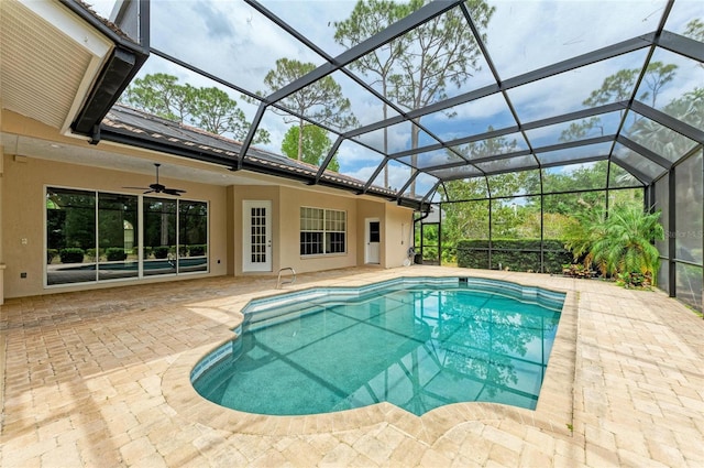 pool with a ceiling fan, a patio, and glass enclosure