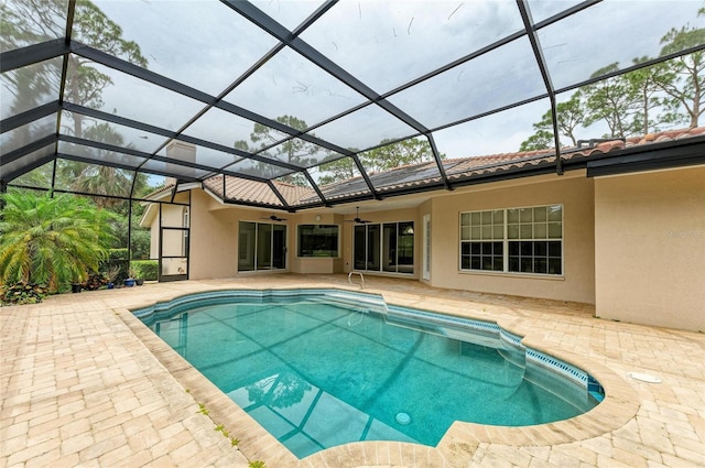 pool with a lanai, ceiling fan, and a patio area