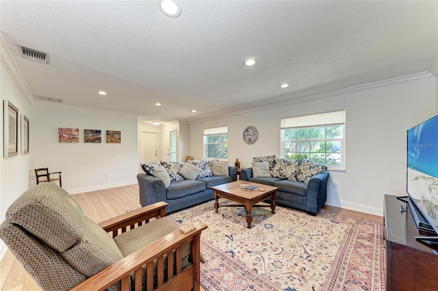living area featuring ornamental molding and light wood-style floors