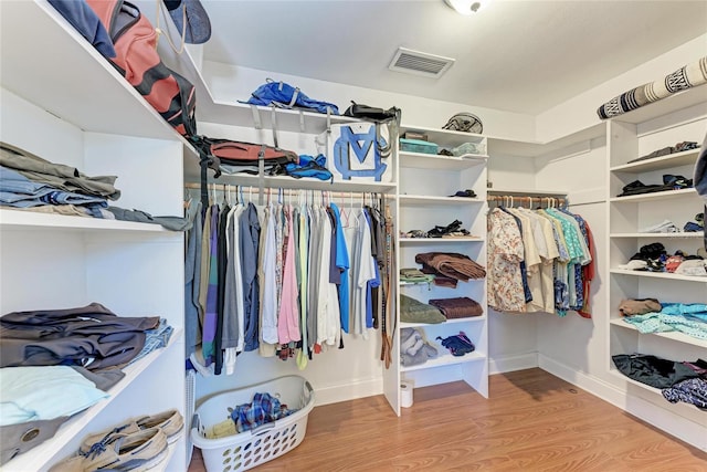 walk in closet featuring visible vents and wood finished floors