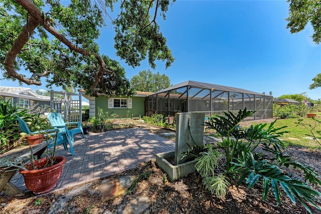 view of patio featuring a lanai