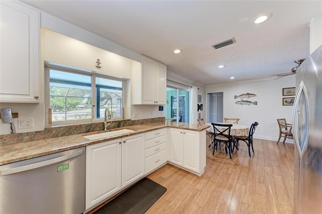 kitchen with white cabinetry, visible vents, appliances with stainless steel finishes, and a sink