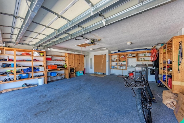 garage with a garage door opener and washer and clothes dryer