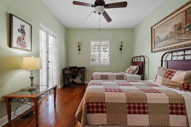 bedroom featuring visible vents, multiple windows, and hardwood / wood-style floors