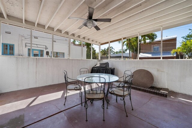 view of patio with ceiling fan, fence, and outdoor dining space