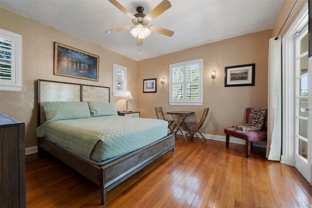 bedroom with baseboards, ceiling fan, and light wood finished floors