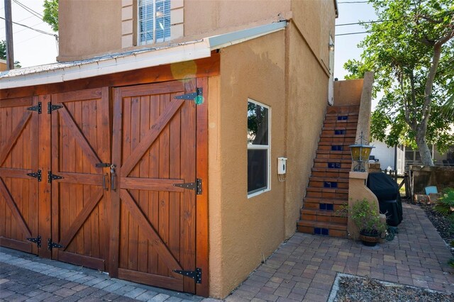 exterior space featuring stairs and an outbuilding